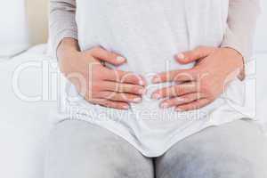 Mid section of woman with stomach pain