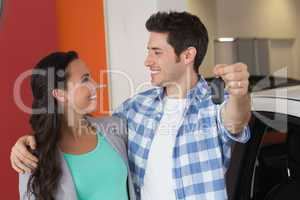 Smiling couple holding their new car key