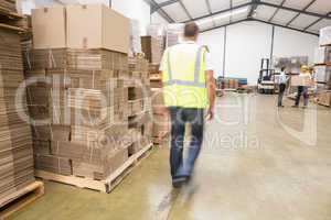Blurred worker walking in warehouse