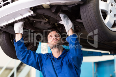 Mechanic examining under the car