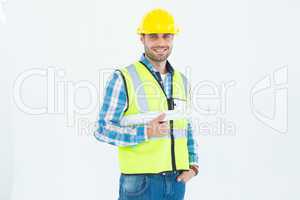 Portrait of smiling architect holding blueprint