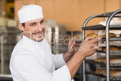 Baker checking freshly baked bread