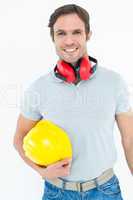 Happy carpenter with hard hat and ear protectors