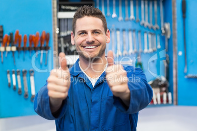 Smiling mechanic looking at camera