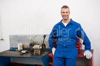 Smiling mechanic looking at camera