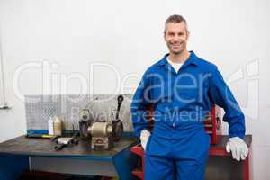 Smiling mechanic looking at camera