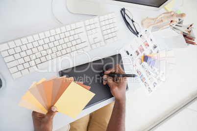 Designer using digitizer and colour wheel