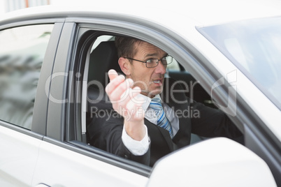 Handsome businessman experiencing road rage