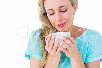 Smiling blonde with hot beverage relaxing