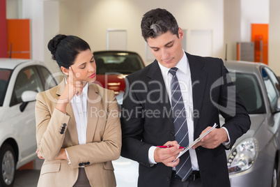 Business team working together on clipboard