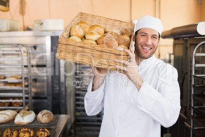 Baker holding basket of bread