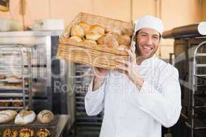 Baker holding basket of bread