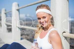 Fit blonde sitting on the pier