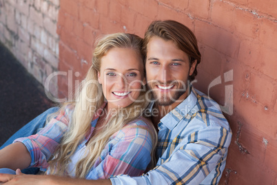 Cute couple sitting on ground