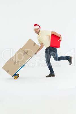Delivery man pushing trolley of boxes during Christmas Delivery man pushing trolley of boxes during Christmas