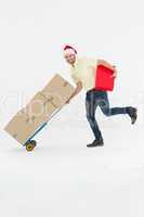 Delivery man pushing trolley of boxes during Christmas