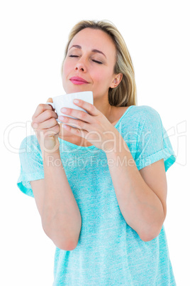 Peaceful blonde with hot beverage relaxing