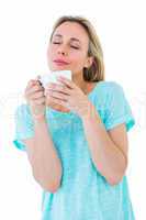 Peaceful blonde with hot beverage relaxing