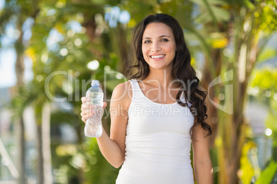 Pretty brunette drinking bottle of water