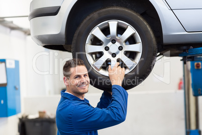 Mechanic adjusting the tire wheel