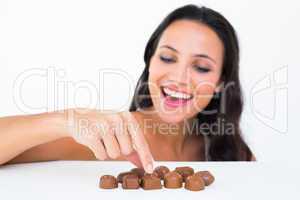 Pretty brunette picking out chocolate