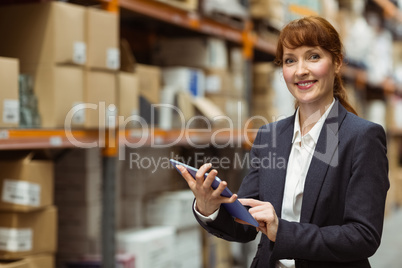 Smiling businesswoman scrolling on digital tablet