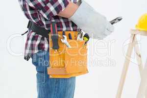 Repairman wearing glove while holding pliers