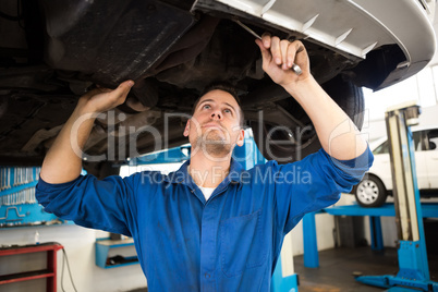 Mechanic examining under the car