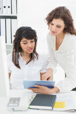 Coworkers using tablet pc together