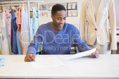 Smiling student reading page of paper