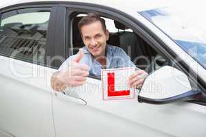 Male driver giving thumbs up while holding his L sign