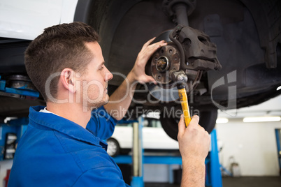 Focused mechanic adjusting the wheel