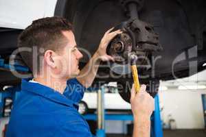 Focused mechanic adjusting the wheel