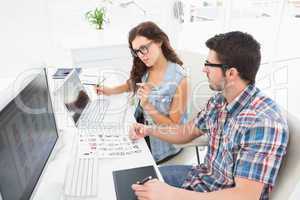 Concentrated coworkers using laptop and digitizer