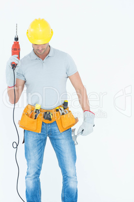 Technician holding drill machine over white background