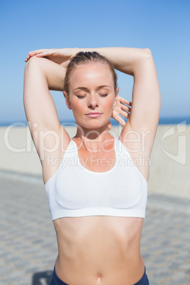 Fit blonde warming up on the pier