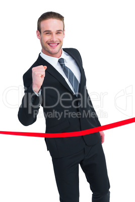 Happy businessman crossing the finish line