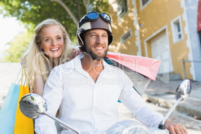 Attractive couple riding a scooter