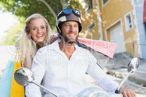 Attractive couple riding a scooter