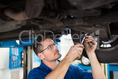 Focused mechanic adjusting the tire wheel