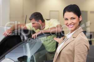 Businesswoman presenting a car to a client