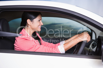 Smiling woman concentrated on the road