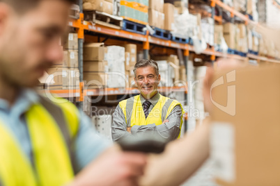 Warehouse worker scanning barcode on box