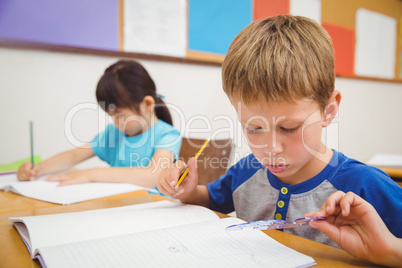 Cute pupils drawing at their desks