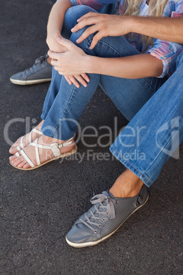 Cute couple sitting on ground