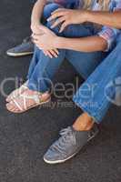 Cute couple sitting on ground