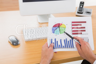 Businessman working on measuring graph at his desk