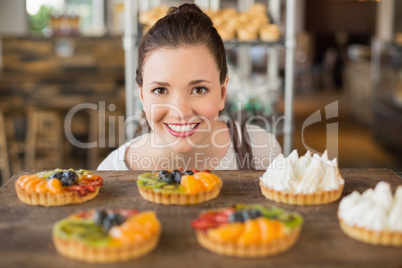 Pretty brunette looking at tarts