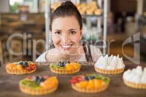Pretty brunette looking at tarts
