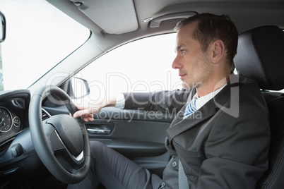 Handsome businessman in the drivers seat